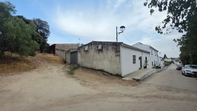 Última casa del pueblo con el encinar pegado y la calle de tierra muriendo ahí